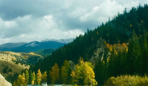 Panoramic view of trees and mountains against sky