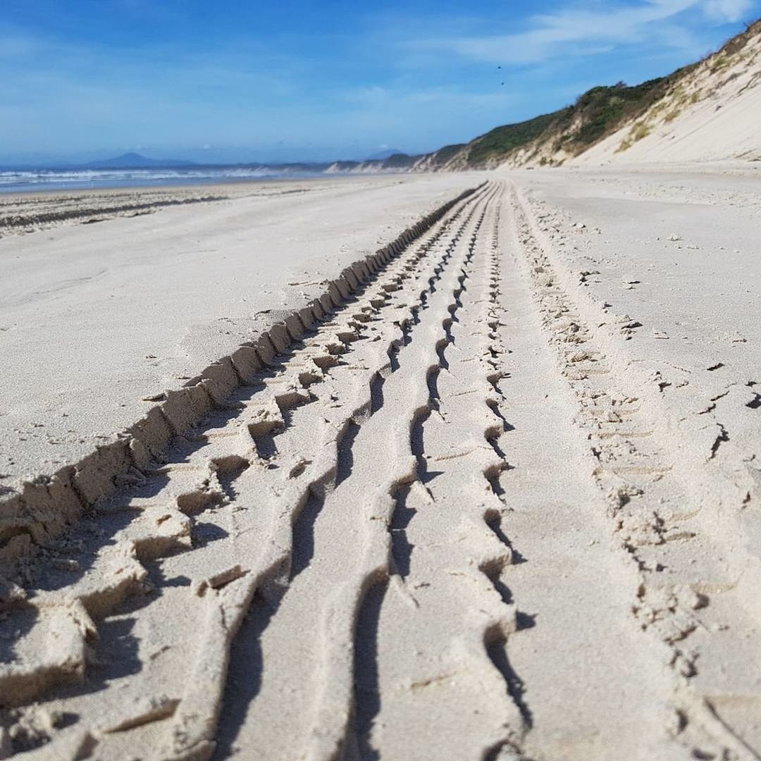 sand, beach, nature, day, outdoors, sunlight, tranquility, beauty in nature, tranquil scene, landscape, tire track, the way forward, sky, scenics, no people, desert, arid climate, sand dune