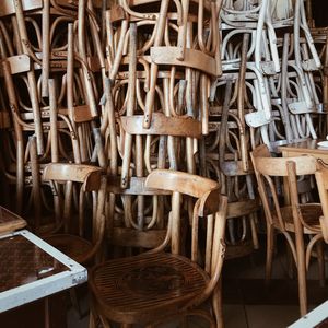 Stacked wooden chairs at store for sale