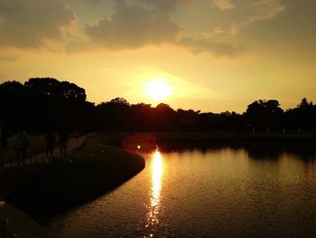 Scenic view of river at sunset