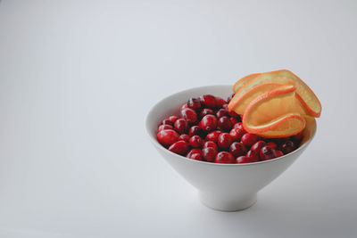 Close-up of strawberries in bowl against white background