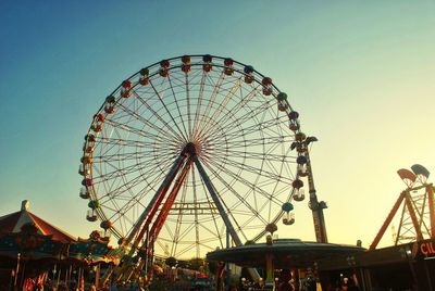 Low angle view of ferris wheel against clear sky