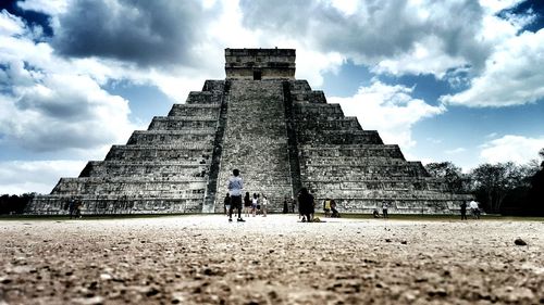 Low angle view of old ruins against cloudy sky