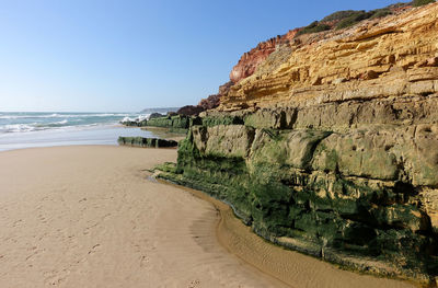 Cliffs and rock formations on the beach of salema on the algarve