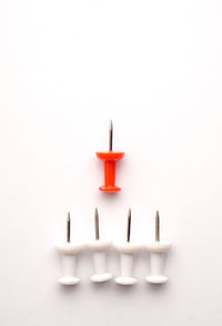 Close-up of burning candle against white background