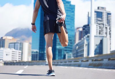 Low section of woman walking on street