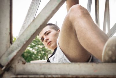 Young man lying down outdoors