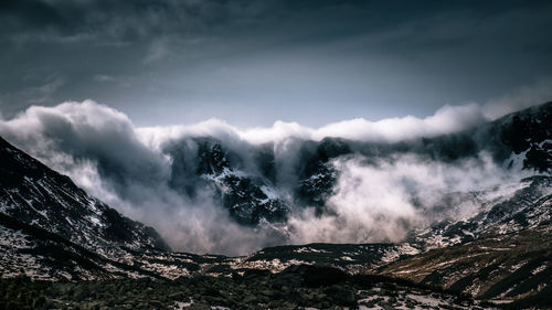 Panoramic view of snowcapped mountains against sky