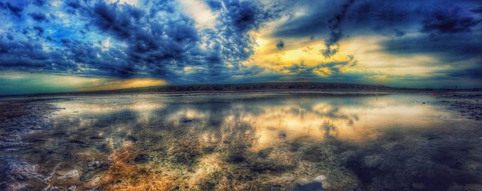 Scenic view of sea against cloudy sky