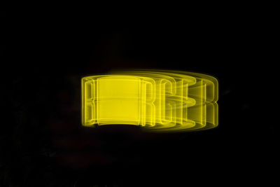 Close-up of yellow light over black background