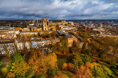 High angle view of townscape by river against sky