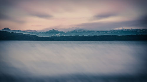 Scenic view of snowcapped mountains against sky during sunset