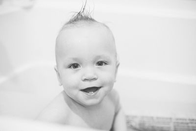 Close-up portrait of boy in bathtub at bathroom