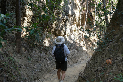 Rear view of woman standing on rock