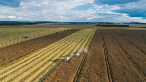 Aerial view of machinery working in agricultural field