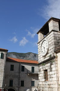 Low angle view of clock tower against sky