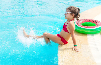 Young woman swimming in pool