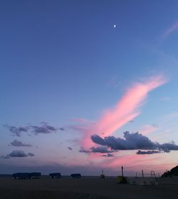 Scenic view of silhouette landscape against blue sky at sunset