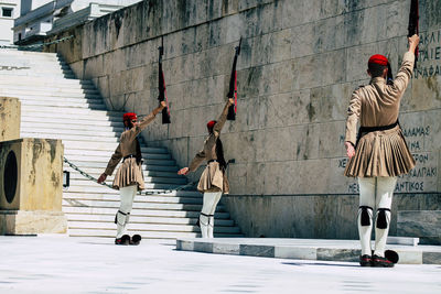 Rear view of people walking on staircase