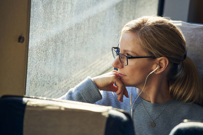 Woman looking through train window