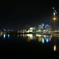 Illuminated city at waterfront