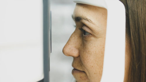 Close-up of woman looking through medical equipment