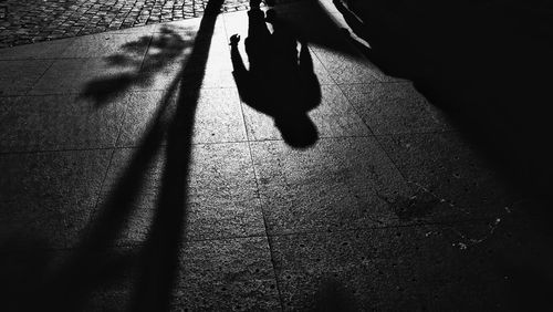 Shadow of woman walking on street