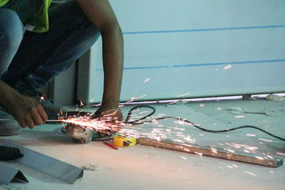 Close-up of man working on metal structure