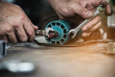 Midsection of man working on table