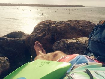 Rear view of man sitting on beach