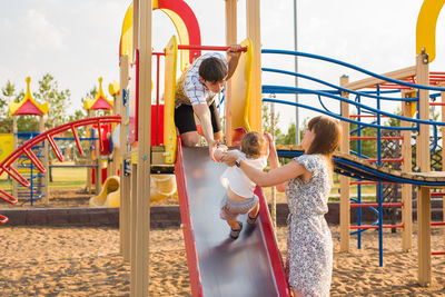 Children playing on slide at playground