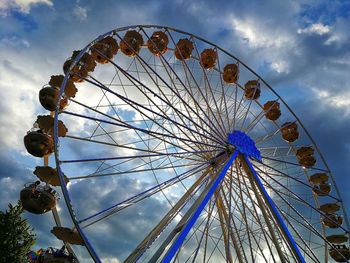 Low angle view of ferris wheel against sky