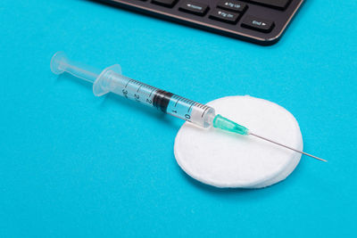 High angle view of blue container on table