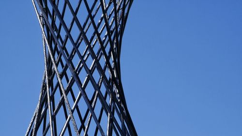 Low angle view of umbrella against clear blue sky