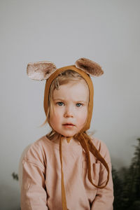 Toddler baby girl in funny hat with ears having fun