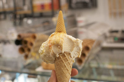 Close-up of hand holding ice cream cone