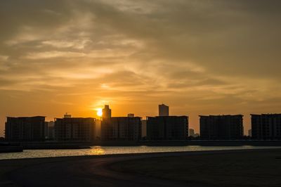 Cityscape against sky during sunset