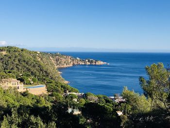 Scenic view of sea against clear blue sky