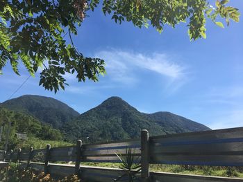 Scenic view of mountains against blue sky