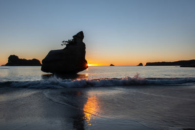 Scenic view of sea against clear sky during sunset