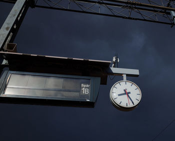 Close-up of clock against the sky