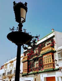 Low angle view of street light against building