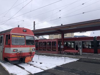 Train at railroad station against sky