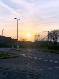 Street against sky during sunset