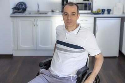 Portrait of mid adult man sitting at home