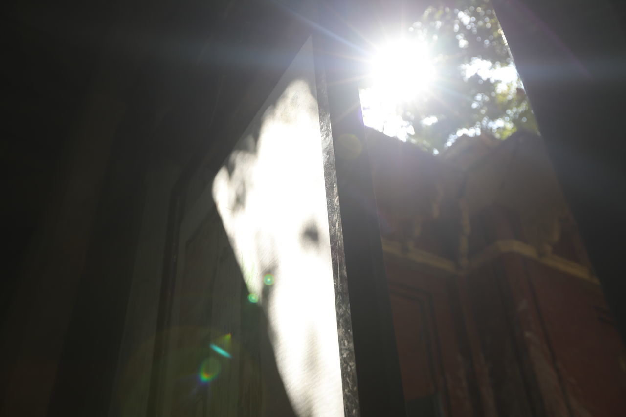 SUNLIGHT STREAMING THROUGH WINDOW AGAINST BRIGHT SUN