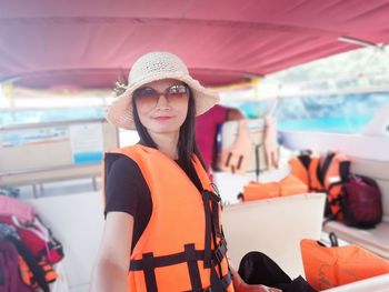 Portrait of young woman standing on boat