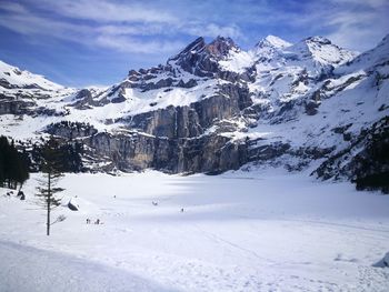 Scenic view of snow covered mountains against sky