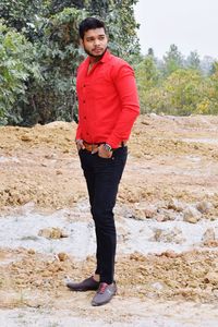 Portrait of young man standing on rock