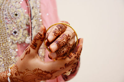 Bride wearing bangles in tattooed hand